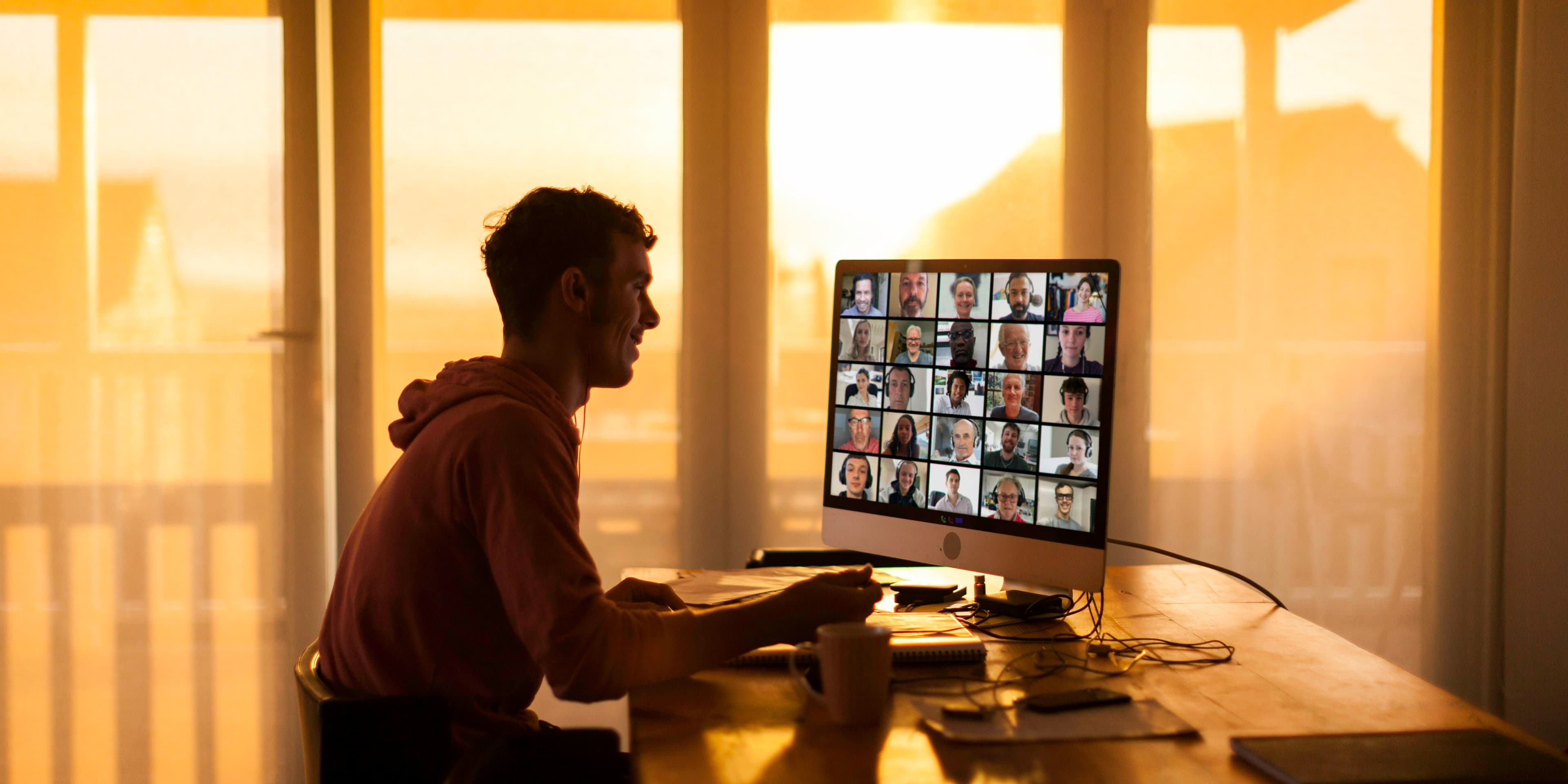 person on a video call with many coworkers