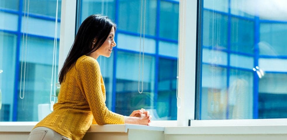 woman looking out window