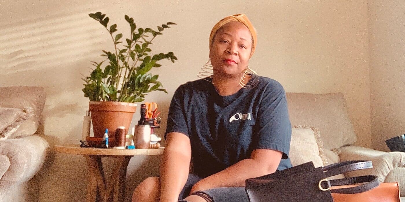 Handbag designer Tree Fairfax sitting on a beige chair