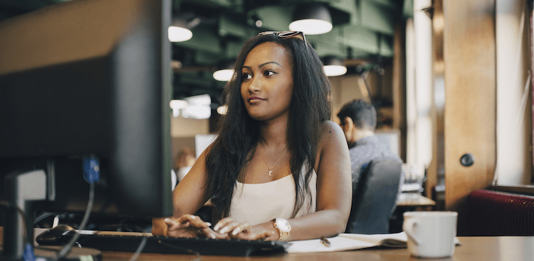 person sitting and working at a computer